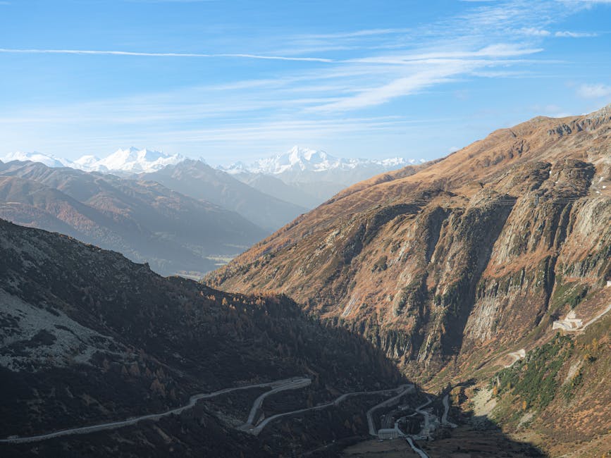 Stunning view of winding roads through Alpine mountains on a clear day.